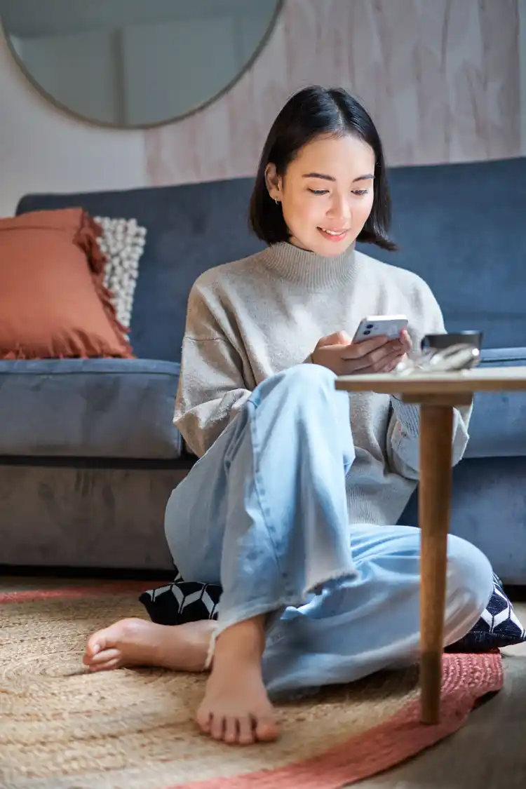 A woman looks at her risk profile on her phone.